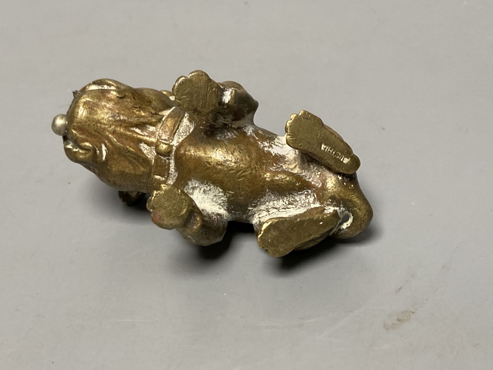 An Austrian bronze bulldog cigar cutter, width 7cm, its mouth concealing the cutter